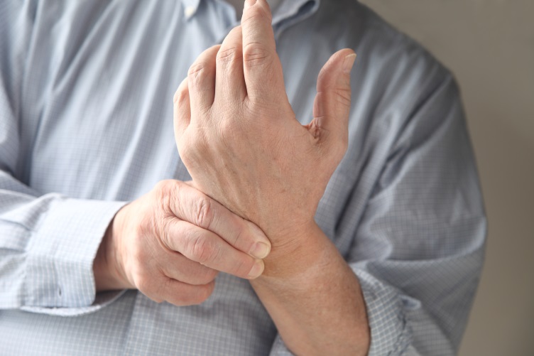man with arthritis pain in wrist
