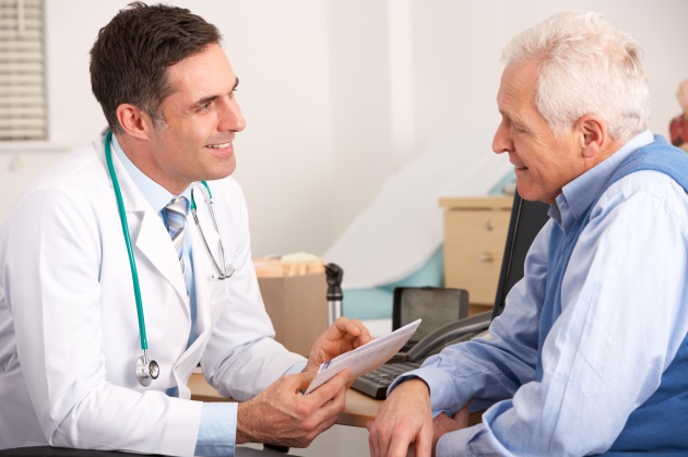 senior man speaking with pain management doctor